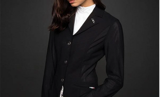 woman with dark hair wearing our aa mesh motion lite show coat in black