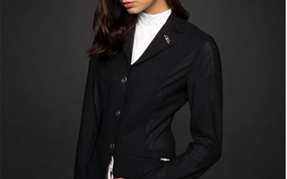woman with dark hair wearing our aa mesh motion lite show coat in black